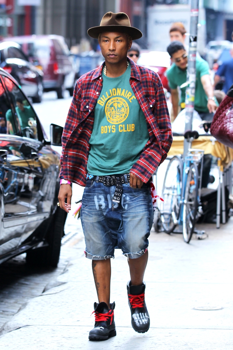 American rapper and fashion designer Pharrell Williams, wearing Billionaire Boys Club clothes with a fedora, drives off in his customized Mercedes-Benz Sprinter Cargo Van 2500 in Soho in New York City